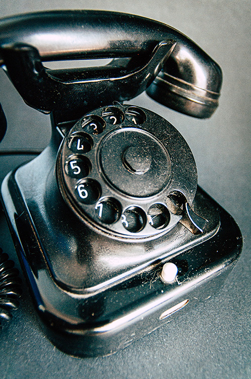 Old fashioned radial dial telephone in black.